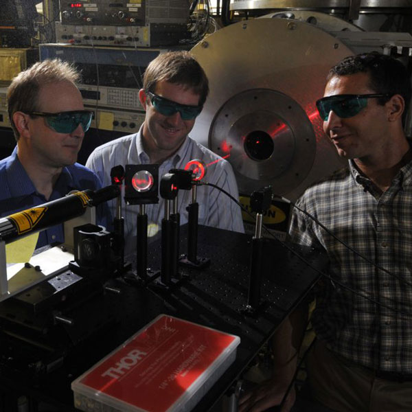 professor and student researching laser