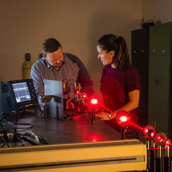 professor and student working with laser 